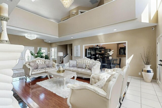 6404 Oak Hill NE, Albuquerque, NM 87111 - living room featuring tile patterned floors, a towering ceiling, and baseboards