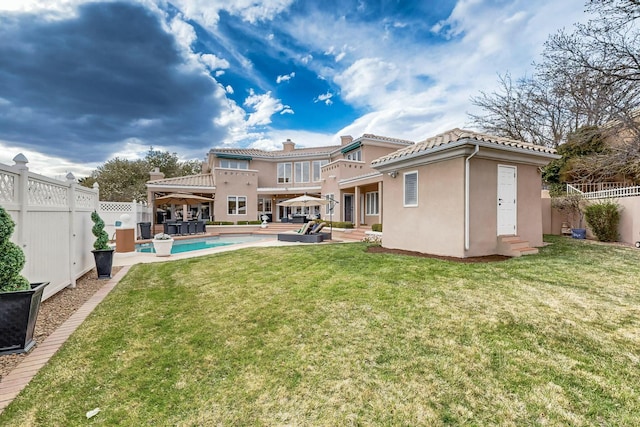 6404 Oak Hill NE, Albuquerque, NM 87111 - back of house with a fenced backyard, stucco siding, a yard, and entry steps