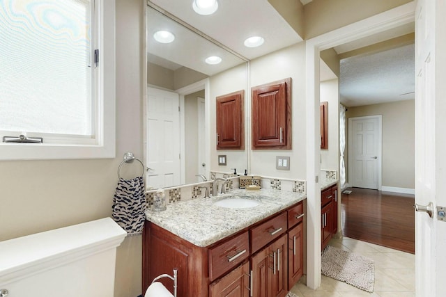 6404 Oak Hill NE, Albuquerque, NM 87111 - bathroom with tile patterned floors, recessed lighting, toilet, and vanity