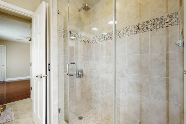 6404 Oak Hill NE, Albuquerque, NM 87111 - bathroom featuring a stall shower, tile patterned floors, and baseboards