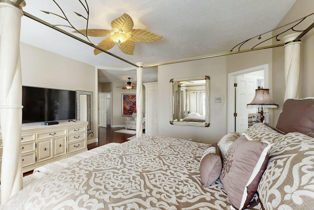 6404 Oak Hill NE, Albuquerque, NM 87111 - bedroom featuring a textured ceiling, a ceiling fan, wood finished floors, and decorative columns