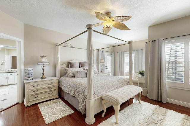 6404 Oak Hill NE, Albuquerque, NM 87111 - bedroom featuring a textured ceiling, baseboards, ceiling fan, and wood finished floors