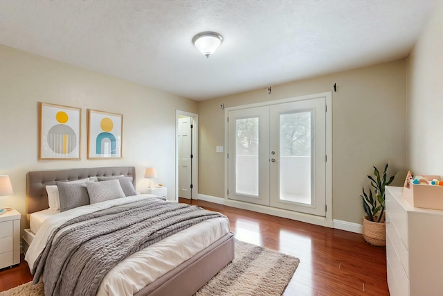 6404 Oak Hill NE, Albuquerque, NM 87111 - bedroom featuring french doors, baseboards, access to exterior, and wood finished floors