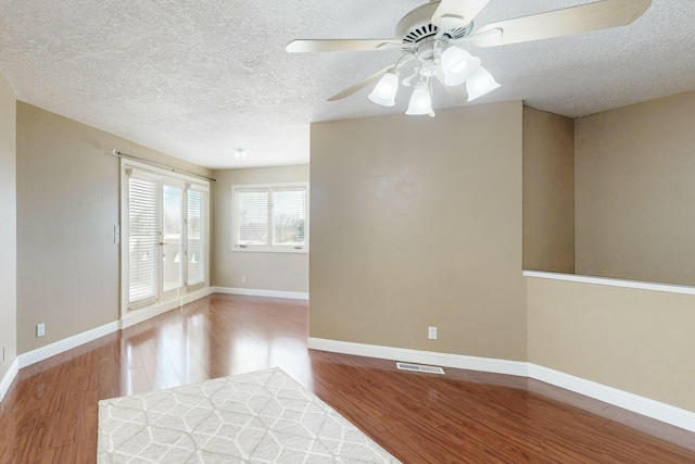 6404 Oak Hill NE, Albuquerque, NM 87111 - empty room featuring baseboards, a textured ceiling, ceiling fan, and wood finished floors