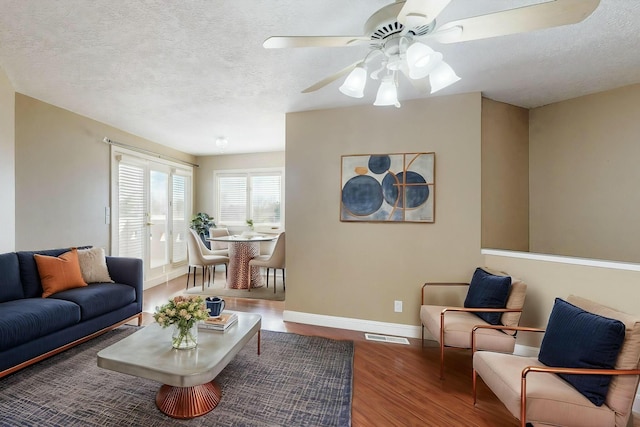 6404 Oak Hill NE, Albuquerque, NM 87111 - living area featuring baseboards, a textured ceiling, wood finished floors, and a ceiling fan