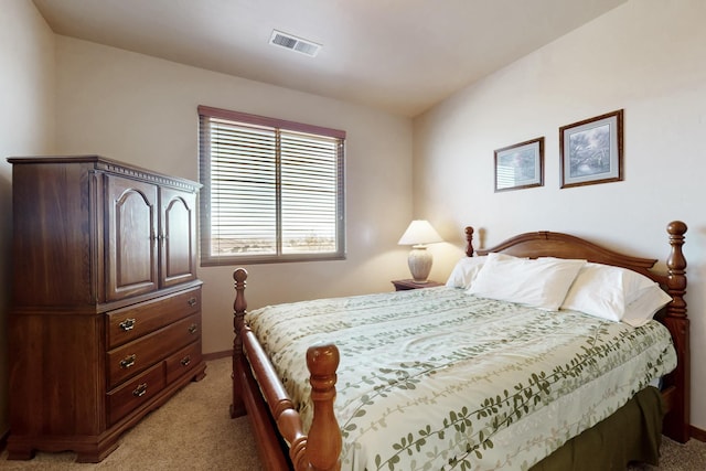 bedroom featuring light colored carpet and visible vents