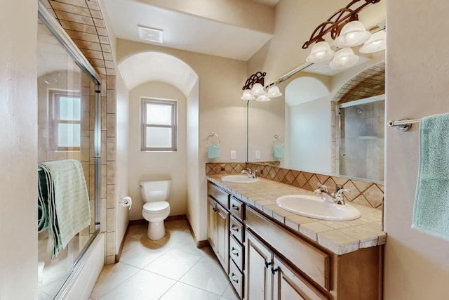 bathroom with visible vents, a sink, toilet, and double vanity