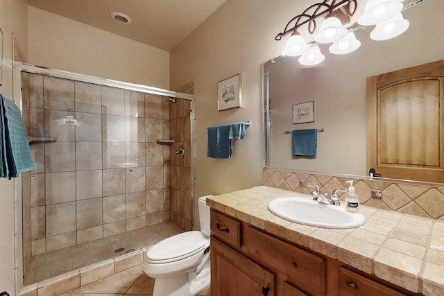 full bathroom with vanity, toilet, decorative backsplash, a shower stall, and a notable chandelier