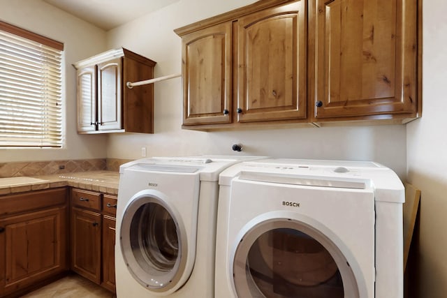 laundry area featuring cabinet space and washing machine and dryer