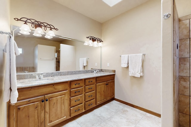 full bathroom featuring double vanity, a sink, and baseboards