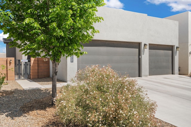 2422 Lynn Rd SE, Rio Rancho, NM 87124 - exterior space featuring a gate, stucco siding, and concrete driveway