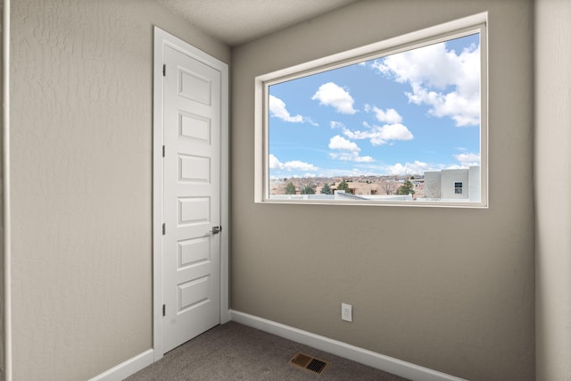 2422 Lynn Rd SE, Rio Rancho, NM 87124 - spare room featuring baseboards, carpet, and visible vents