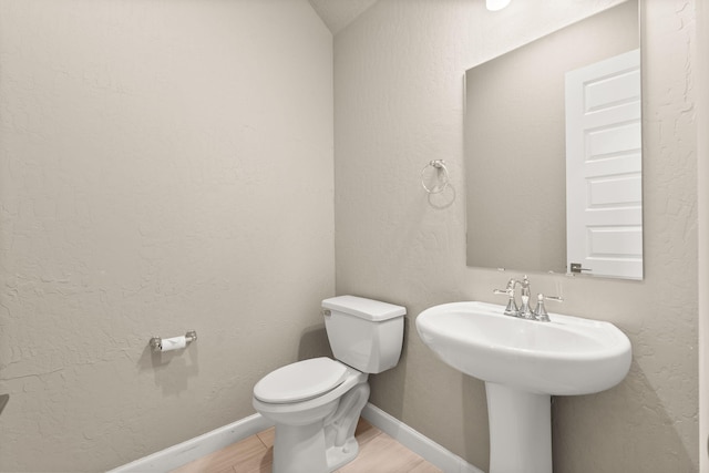 2422 Lynn Rd SE, Rio Rancho, NM 87124 - half bath featuring baseboards, a sink, wood finished floors, and toilet