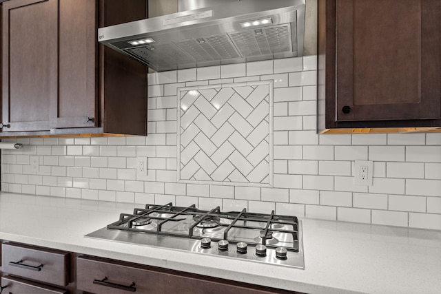 2422 Lynn Rd SE, Rio Rancho, NM 87124 - kitchen with stainless steel gas cooktop, dark brown cabinets, ventilation hood, and light countertops