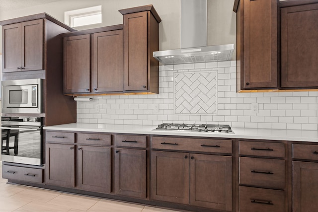 2422 Lynn Rd SE, Rio Rancho, NM 87124 - kitchen featuring light countertops, tasteful backsplash, wall chimney range hood, and stainless steel appliances