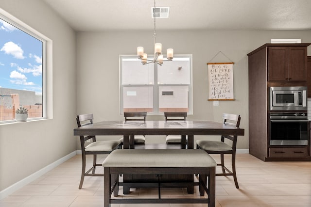 2422 Lynn Rd SE, Rio Rancho, NM 87124 - dining space featuring baseboards, visible vents, and an inviting chandelier
