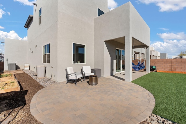 2422 Lynn Rd SE, Rio Rancho, NM 87124 - back of property with fence, stucco siding, a yard, and a patio area