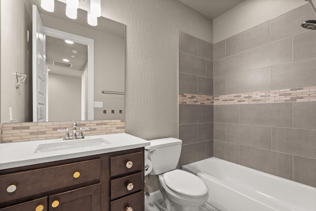 2422 Lynn Rd SE, Rio Rancho, NM 87124 - full bathroom featuring visible vents, vanity, a textured wall, toilet, and tasteful backsplash