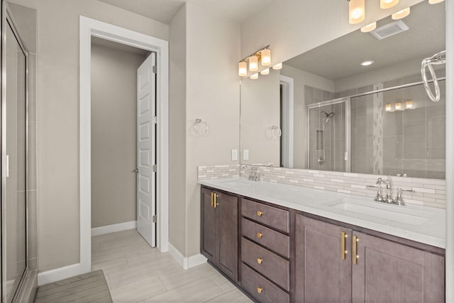 2422 Lynn Rd SE, Rio Rancho, NM 87124 - full bathroom with visible vents, a sink, decorative backsplash, and a shower stall