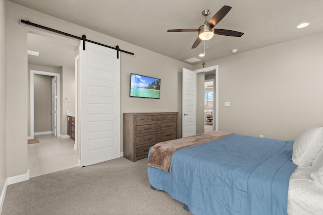 2422 Lynn Rd SE, Rio Rancho, NM 87124 - bedroom featuring light colored carpet, a barn door, and ceiling fan