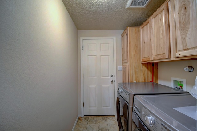 10916 Calandrias St NW, Albuquerque, NM 87114 - laundry area featuring a textured ceiling, baseboards, independent washer and dryer, visible vents, and cabinet space