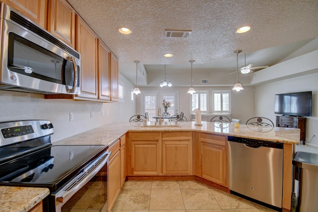 10916 Calandrias St NW, Albuquerque, NM 87114 - kitchen featuring a sink, a ceiling fan, appliances with stainless steel finishes, a textured ceiling, and visible vents