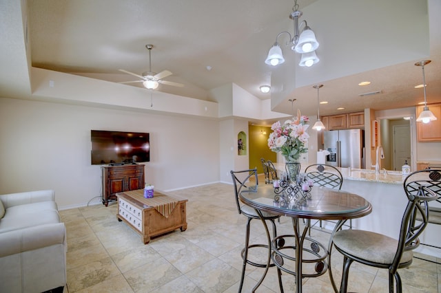 10916 Calandrias St NW, Albuquerque, NM 87114 - dining space with ceiling fan with notable chandelier, lofted ceiling, and baseboards