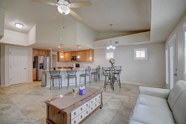10916 Calandrias St NW, Albuquerque, NM 87114 - living area with lofted ceiling, baseboards, a textured ceiling, visible vents, and a ceiling fan