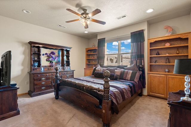 bedroom featuring visible vents, ceiling fan, and light carpet
