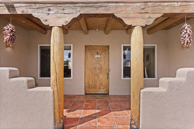 entrance to property with a patio area and stucco siding