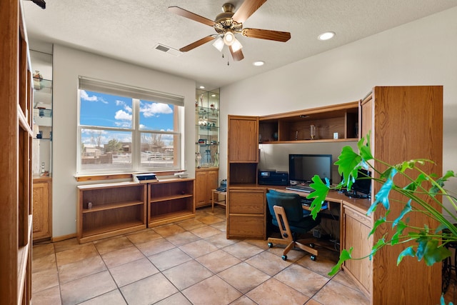 home office with a textured ceiling, built in study area, a ceiling fan, and recessed lighting