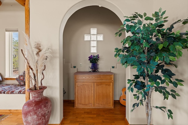 interior details with arched walkways and wood finished floors