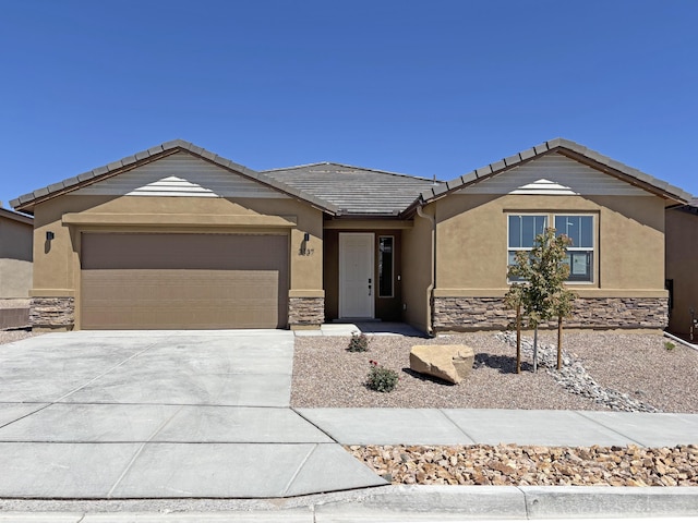 3329 Wolf Tail Loop NE, Rio Rancho, NM 87144 - ranch-style home with stone siding, a garage, stucco siding, driveway, and a tiled roof