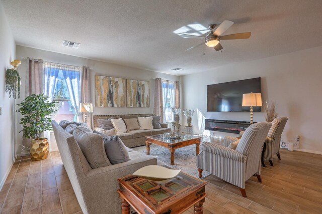 8717 Sevano Cir NE, Albuquerque, NM 87113 - dining room featuring wood finished floors, a textured ceiling, and a ceiling fan