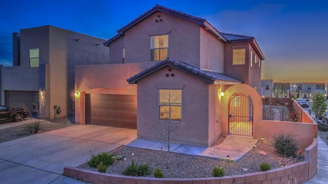 8717 Sevano Cir NE, Albuquerque, NM 87113 - mediterranean / spanish home with a tile roof, stucco siding, driveway, and a patio area