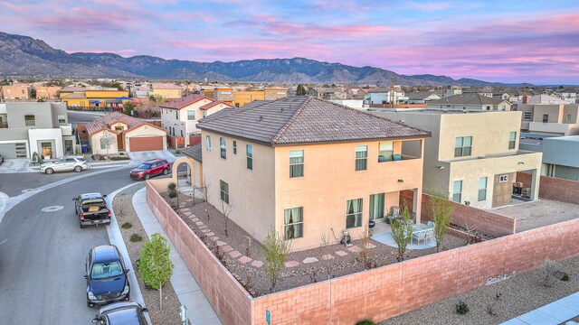 8717 Sevano Cir NE, Albuquerque, NM 87113 - patio terrace at dusk featuring a fenced backyard and outdoor dining space