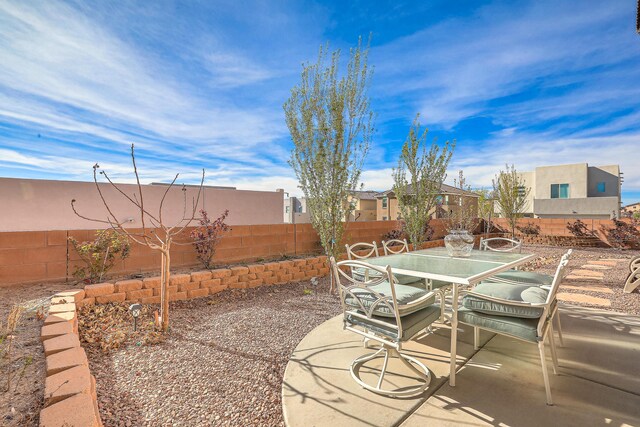 8717 Sevano Cir NE, Albuquerque, NM 87113 - view of asphalt road featuring a gate, curbs, and a gated entry