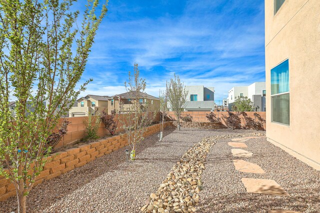 8717 Sevano Cir NE, Albuquerque, NM 87113 - view of side of home featuring stucco siding and a tiled roof