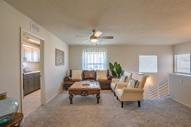 8717 Sevano Cir NE, Albuquerque, NM 87113 - living room with light carpet, a textured ceiling, healthy amount of natural light, and ceiling fan