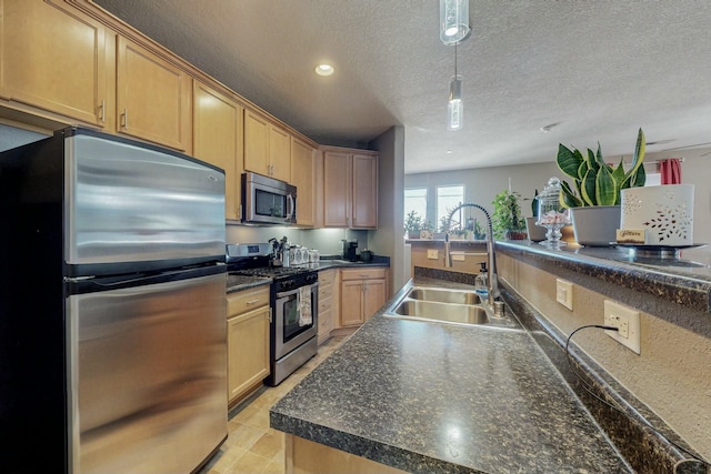 601 Menaul Blvd NE Unit 306, Albuquerque, NM 87107 - kitchen with a textured ceiling, dark countertops, appliances with stainless steel finishes, a sink, and pendant lighting