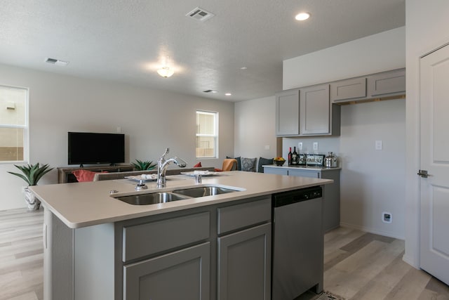 9620 Sage Ranch Ct SW, Albuquerque, NM 87121 - kitchen with stainless steel dishwasher, gray cabinetry, light wood-type flooring, open floor plan, and an island with sink
