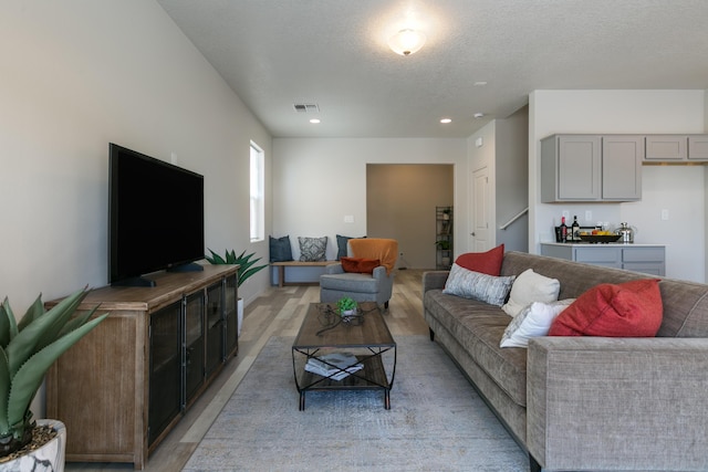 9620 Sage Ranch Ct SW, Albuquerque, NM 87121 - living room featuring light wood-style floors, a textured ceiling, recessed lighting, and stairway