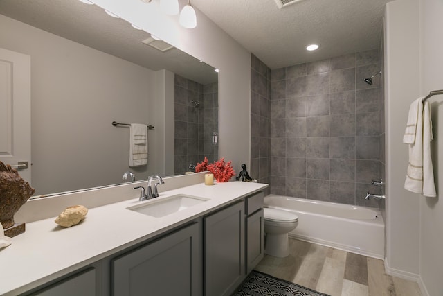9620 Sage Ranch Ct SW, Albuquerque, NM 87121 - bathroom with wood finished floors, vanity, bathtub / shower combination, a textured ceiling, and recessed lighting
