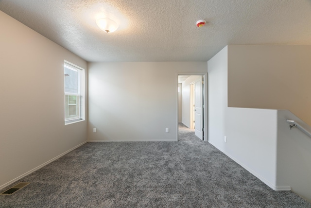 9600 Sage Ranch Ct SW, Albuquerque, NM 87121 - spare room featuring carpet flooring, a textured ceiling, and a smoke detector