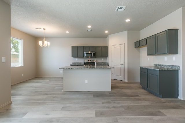 9600 Sage Ranch Ct SW, Albuquerque, NM 87121 - kitchen featuring stainless steel appliances, a chandelier, light stone counters, recessed lighting, and a textured ceiling