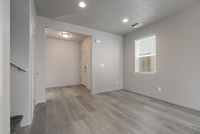 9600 Sage Ranch Ct SW, Albuquerque, NM 87121 - spare room with light wood-style flooring, a textured ceiling, and recessed lighting