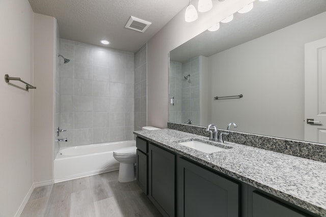 9600 Sage Ranch Ct SW, Albuquerque, NM 87121 - bathroom featuring vanity, wood finished floors,  shower combination, and a textured ceiling