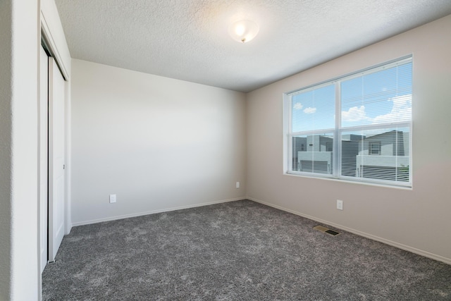 9600 Sage Ranch Ct SW, Albuquerque, NM 87121 - unfurnished bedroom with carpet, a textured ceiling, and a closet