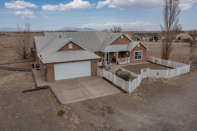 traditional-style home with a porch, fence private yard, stucco siding, and driveway