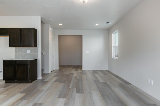 9504 Sage Ranch Ct SW, Albuquerque, NM 87121 - kitchen featuring light countertops, light wood-style floors, dark brown cabinets, recessed lighting, and open floor plan